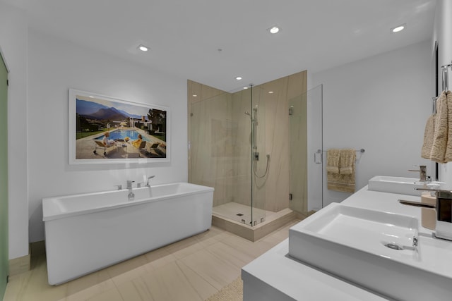 bathroom with tile patterned flooring, sink, and plus walk in shower