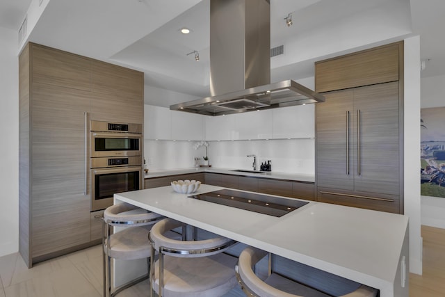 kitchen featuring a breakfast bar area, white cabinetry, black electric cooktop, island exhaust hood, and stainless steel double oven