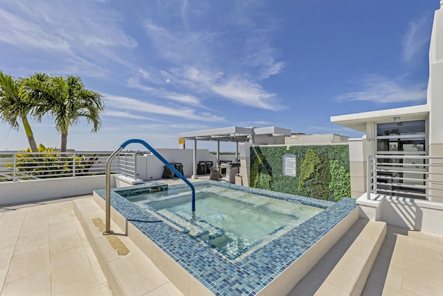 view of swimming pool with a hot tub