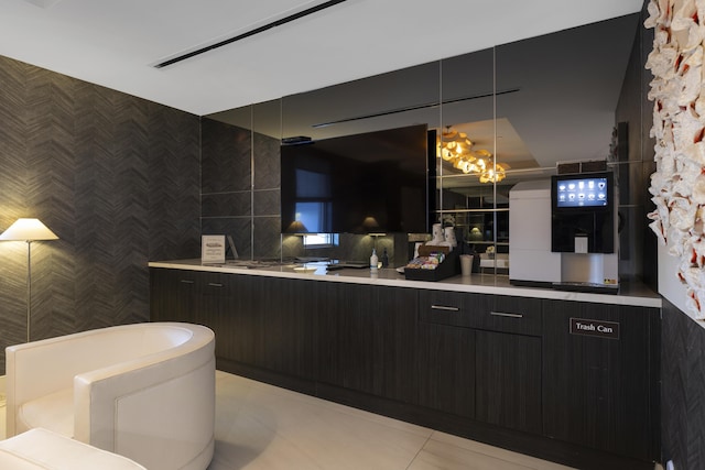 bathroom featuring tile walls, a notable chandelier, and tile patterned floors