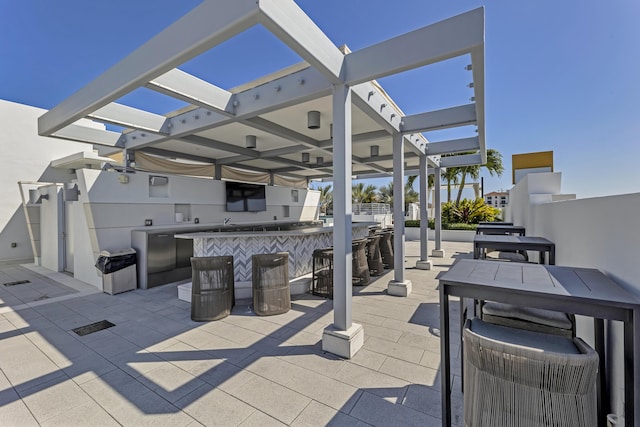 view of patio / terrace with a pergola and a bar