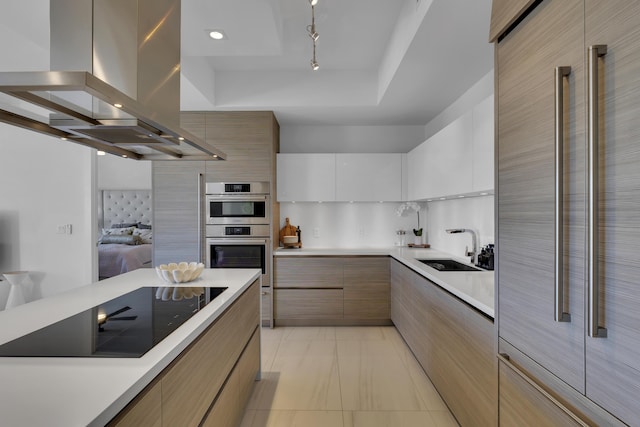 kitchen featuring sink, white cabinetry, double oven, island exhaust hood, and black electric stovetop