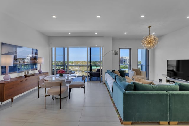 living room featuring light tile patterned floors and an inviting chandelier