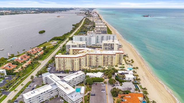 birds eye view of property featuring a water view and a beach view