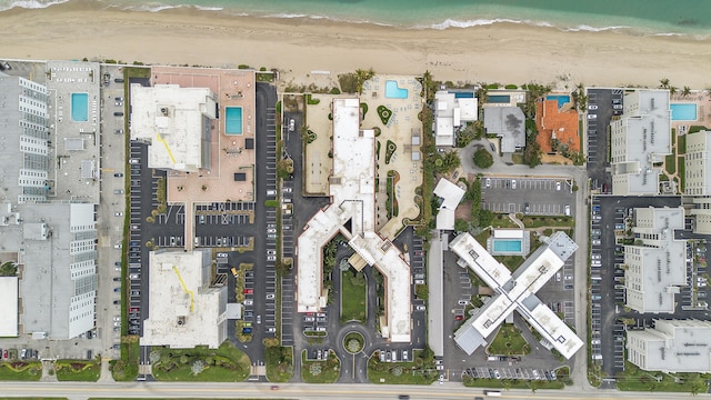 drone / aerial view with a water view and a view of the beach