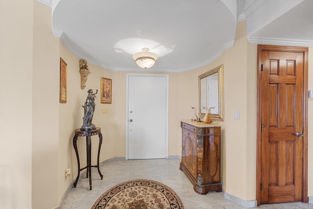 foyer featuring crown molding and a textured ceiling