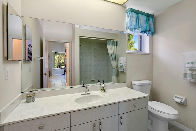 bathroom featuring vanity, curtained shower, and toilet