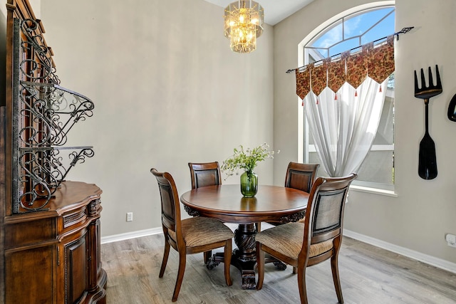 dining space with a chandelier and light hardwood / wood-style floors