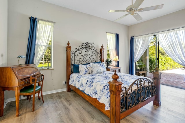 bedroom with access to outside, multiple windows, ceiling fan, and light hardwood / wood-style flooring