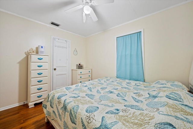 bedroom with ornamental molding, ceiling fan, and dark wood-type flooring