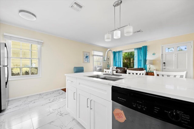 kitchen featuring appliances with stainless steel finishes, light stone counters, sink, decorative light fixtures, and white cabinets