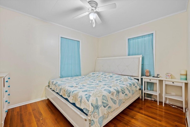 bedroom with ceiling fan, crown molding, and dark wood-type flooring