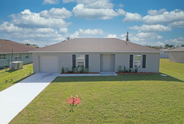 ranch-style home featuring cooling unit, a garage, and a front yard