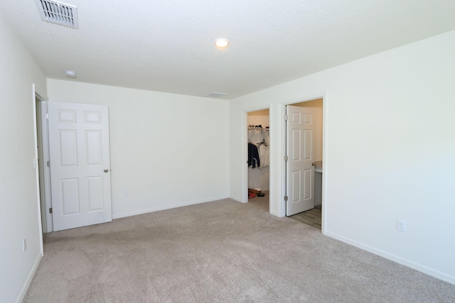 carpeted empty room with a textured ceiling