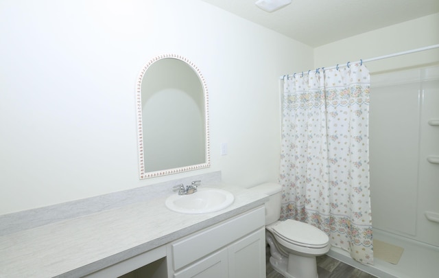 bathroom with vanity, hardwood / wood-style flooring, and toilet