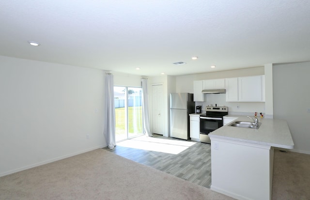 kitchen featuring white cabinets, kitchen peninsula, sink, and appliances with stainless steel finishes