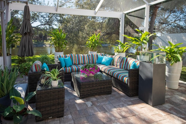 sunroom / solarium featuring a wealth of natural light and a water view