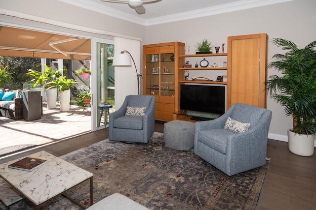 living area with ceiling fan, dark hardwood / wood-style floors, and ornamental molding