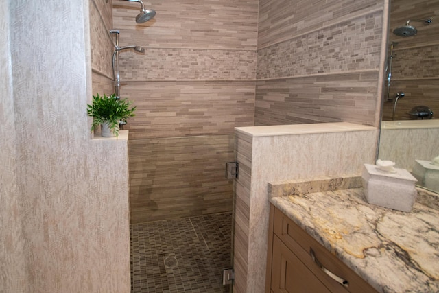 bathroom with an enclosed shower and vanity