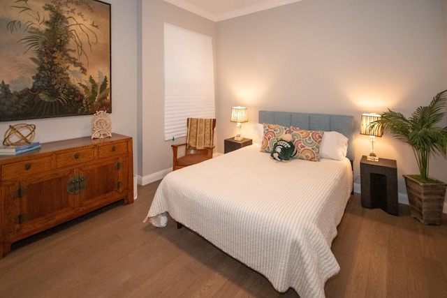 bedroom with ornamental molding and light hardwood / wood-style floors