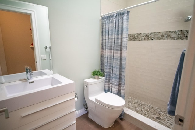 bathroom featuring toilet, vanity, and walk in shower