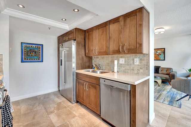 kitchen featuring a raised ceiling, sink, decorative backsplash, ornamental molding, and appliances with stainless steel finishes