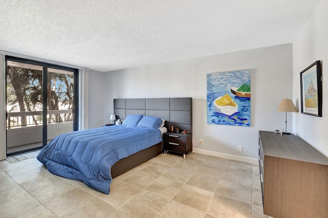 bedroom with access to exterior, a textured ceiling, and floor to ceiling windows