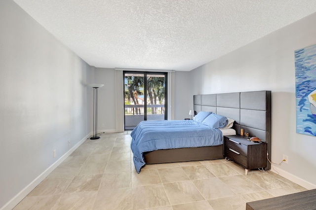 bedroom featuring a textured ceiling and access to outside