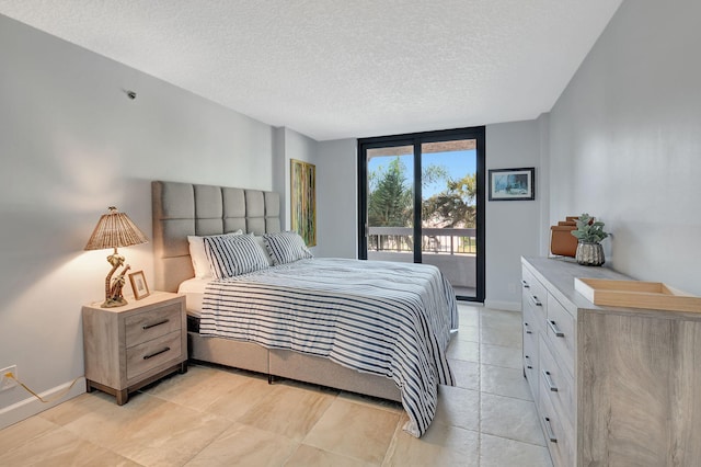 bedroom featuring access to exterior and a textured ceiling