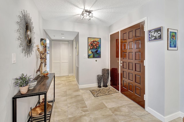 entrance foyer with a textured ceiling