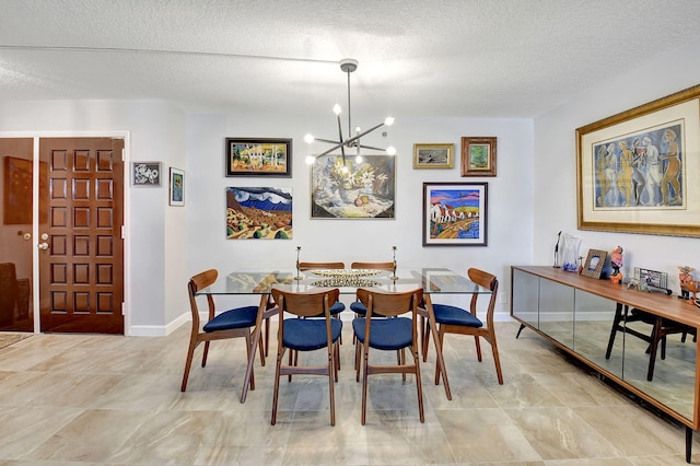 dining space featuring a textured ceiling and an inviting chandelier