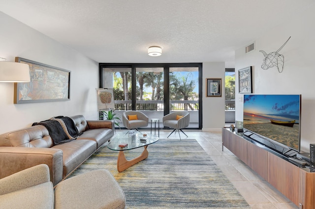 living room featuring light tile patterned floors and a textured ceiling