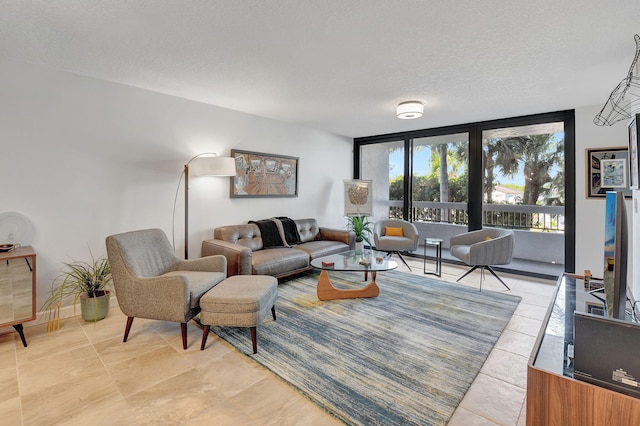 living room with expansive windows, light tile patterned flooring, and a textured ceiling