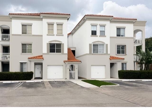 mediterranean / spanish-style home featuring a garage