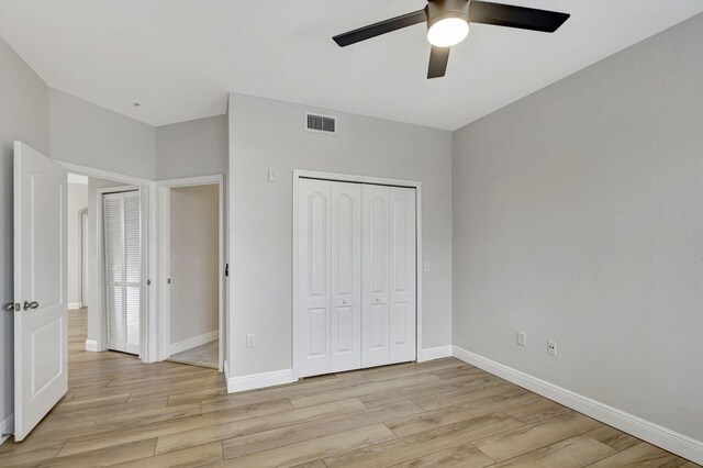 unfurnished bedroom featuring ceiling fan and light wood-type flooring