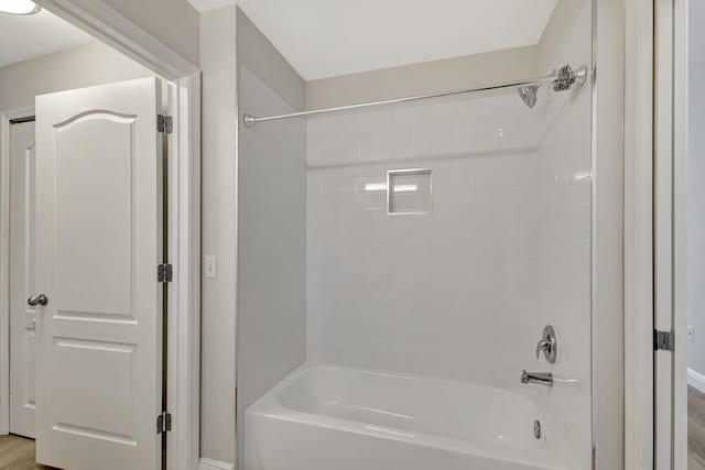 bathroom featuring shower / bathing tub combination and hardwood / wood-style flooring