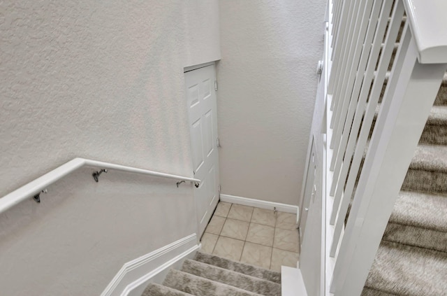 stairs with tile patterned flooring