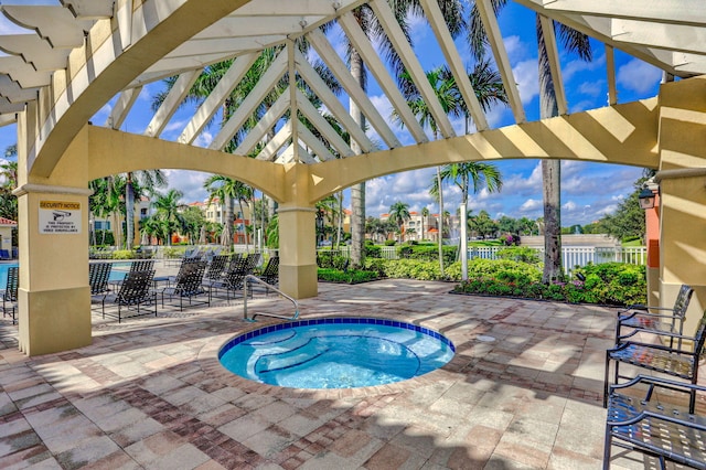 view of swimming pool with a community hot tub and a patio area