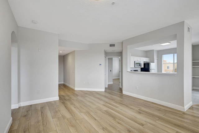 unfurnished living room with light hardwood / wood-style flooring