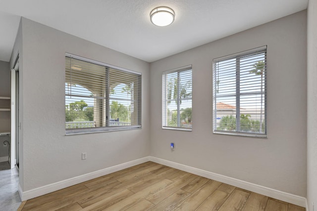 unfurnished room featuring light hardwood / wood-style flooring