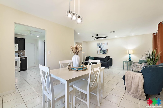 tiled dining room featuring ceiling fan