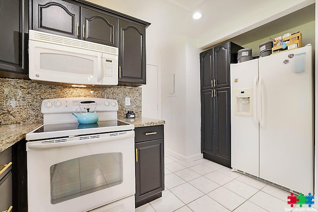 kitchen featuring light stone counters, white appliances, light tile patterned floors, and tasteful backsplash