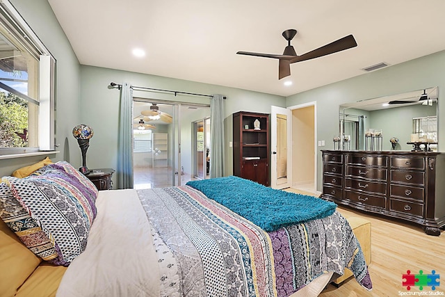 bedroom with ceiling fan and light hardwood / wood-style flooring