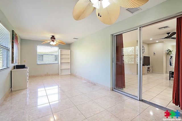 spare room featuring ceiling fan and light tile patterned floors