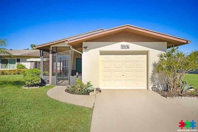 view of front of home with a front yard and a garage