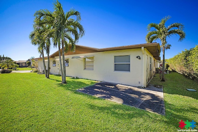 view of side of home with a lawn