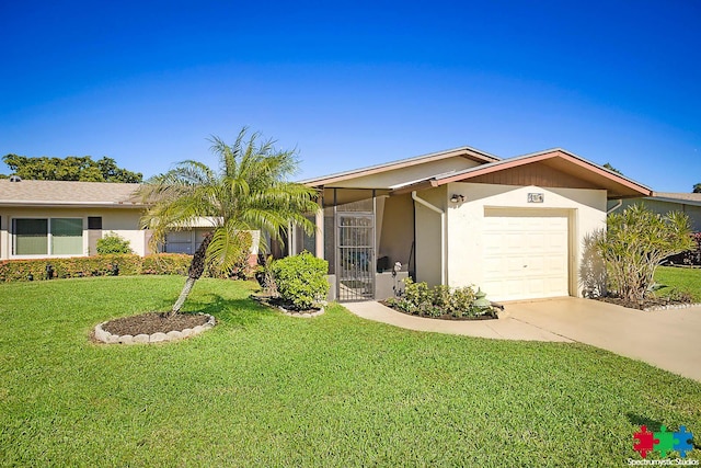 single story home featuring a garage and a front lawn