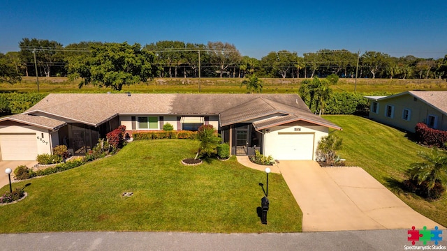 single story home with a front yard and a garage