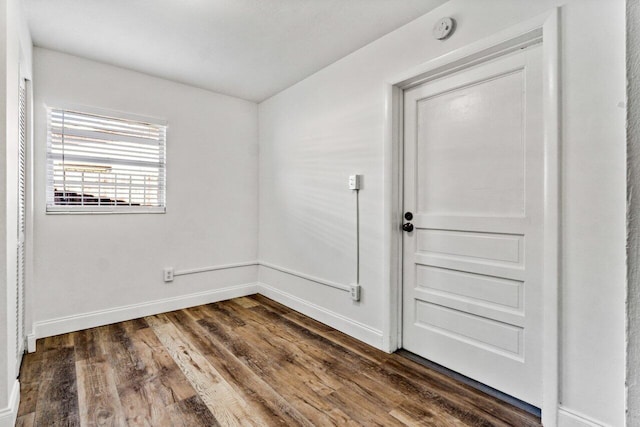 empty room with dark wood-type flooring