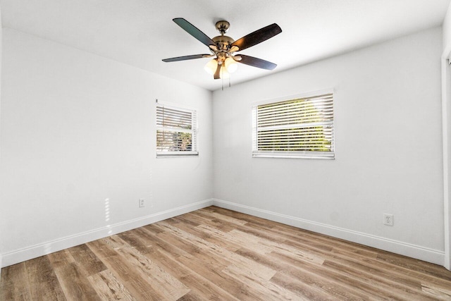 spare room with ceiling fan and light wood-type flooring